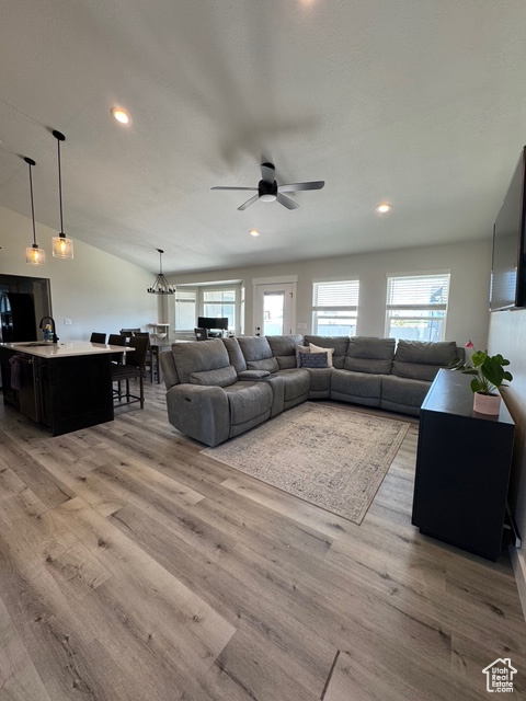 Living room featuring a ceiling fan, light wood-type flooring, and recessed lighting