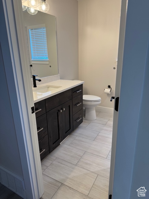 Bathroom featuring vanity and toilet
