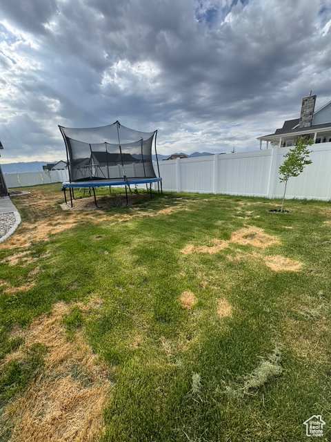 View of yard with a trampoline