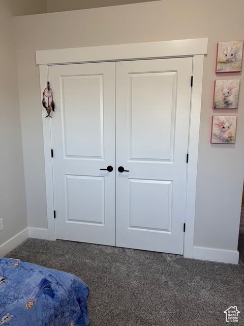 Bedroom with carpet and a closet