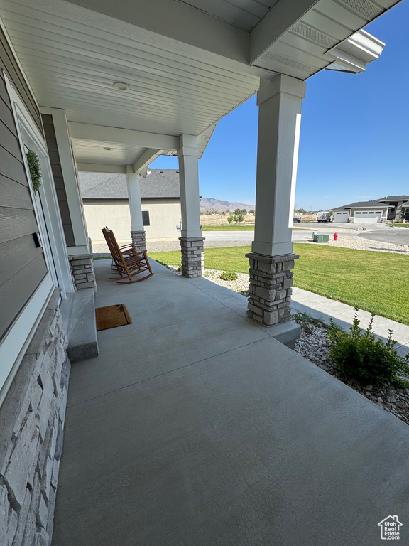 Porch with a lawn and a mountain view