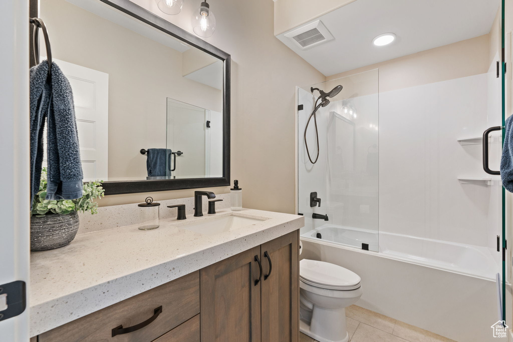 Bathroom with vanity, bathing tub / shower combination, and tile patterned floors