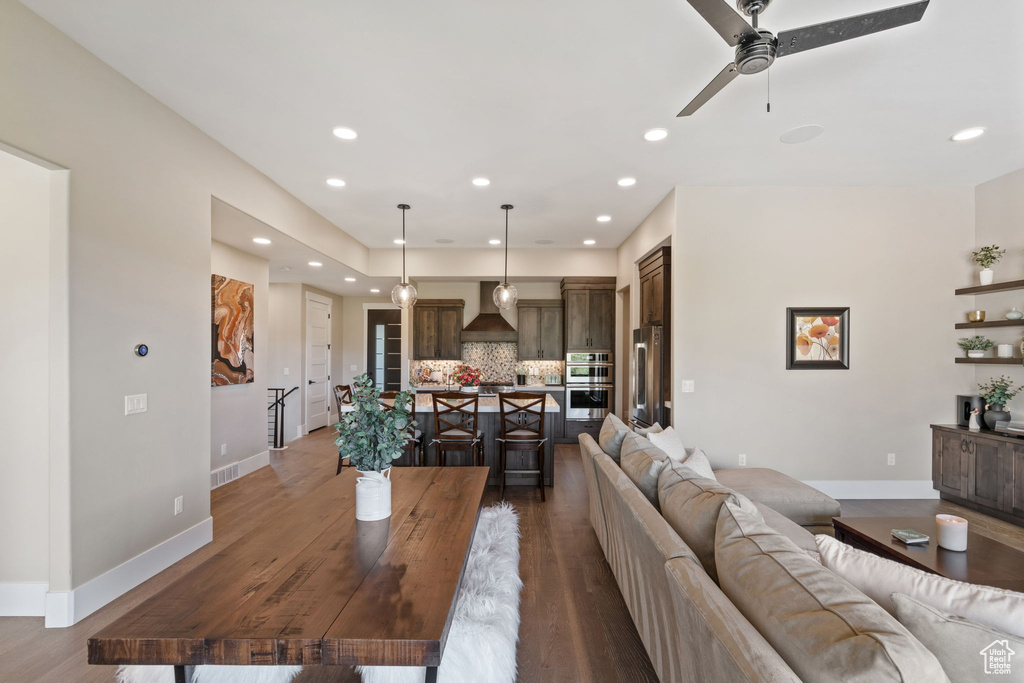 Living area with ceiling fan, recessed lighting, and wood finished floors