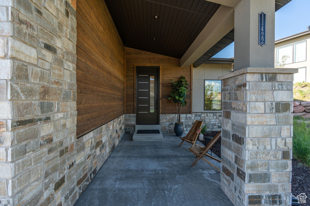 Doorway to property featuring stone siding