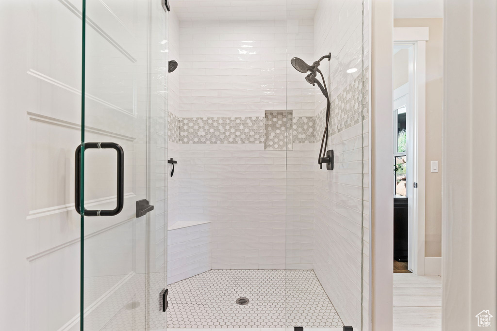 Full bathroom featuring a shower stall