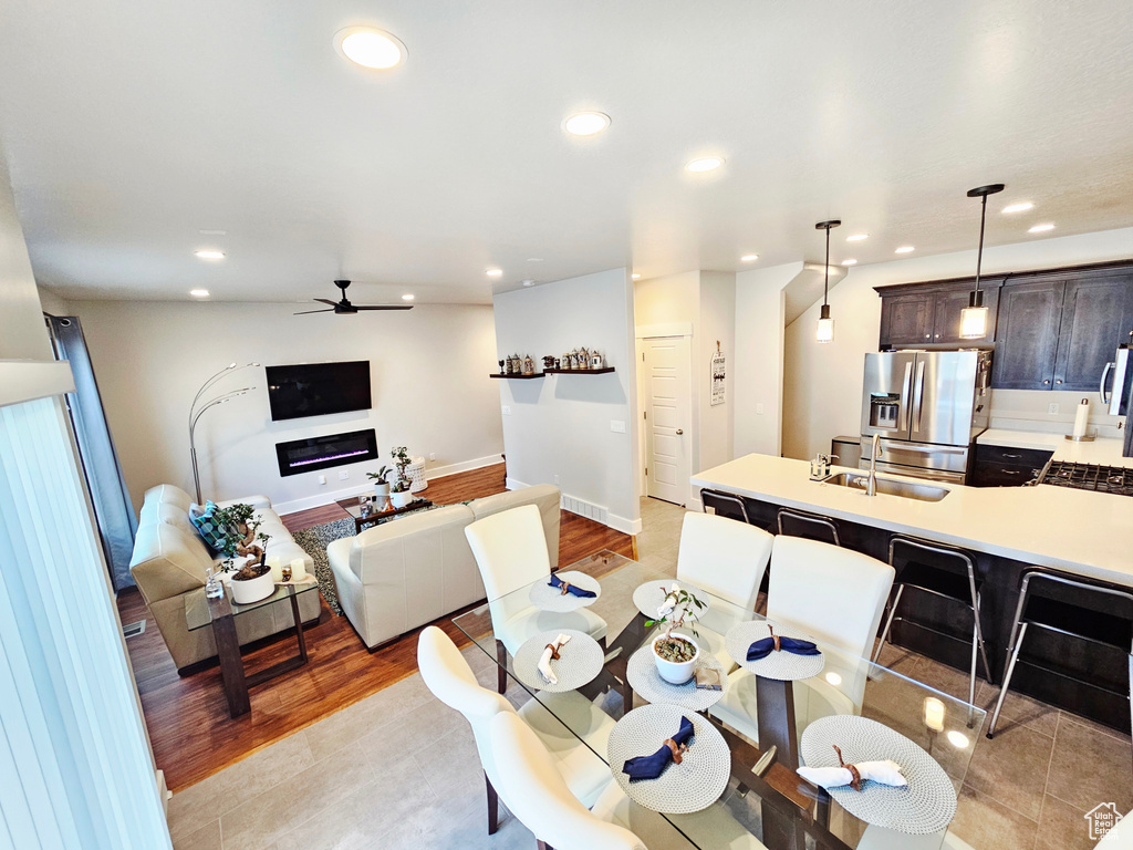 Dining area with ceiling fan, recessed lighting, and light wood-style flooring