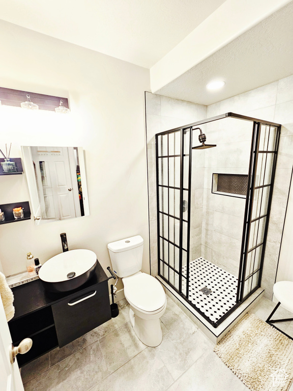 Bathroom featuring a stall shower and vanity