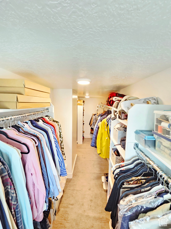 Walk in closet featuring light carpet