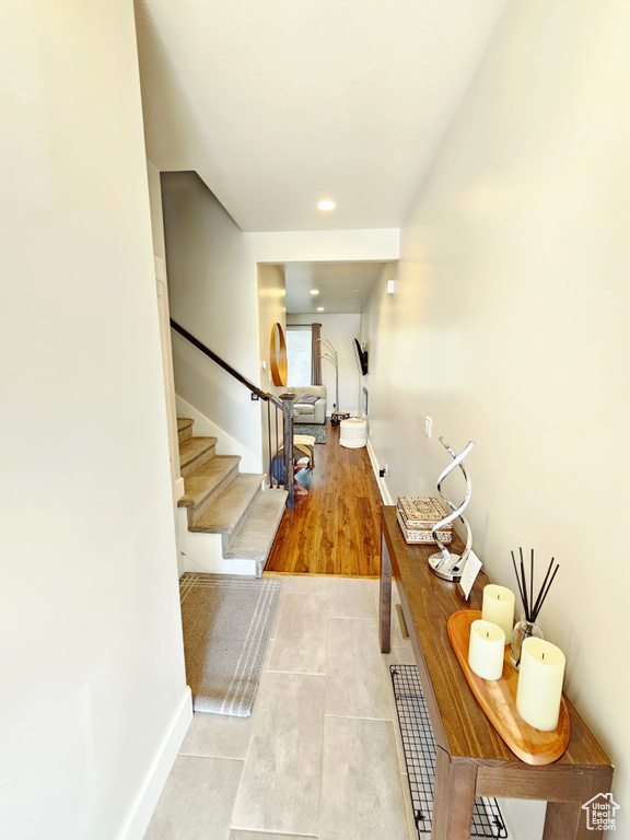 Tiled foyer with stairway and recessed lighting