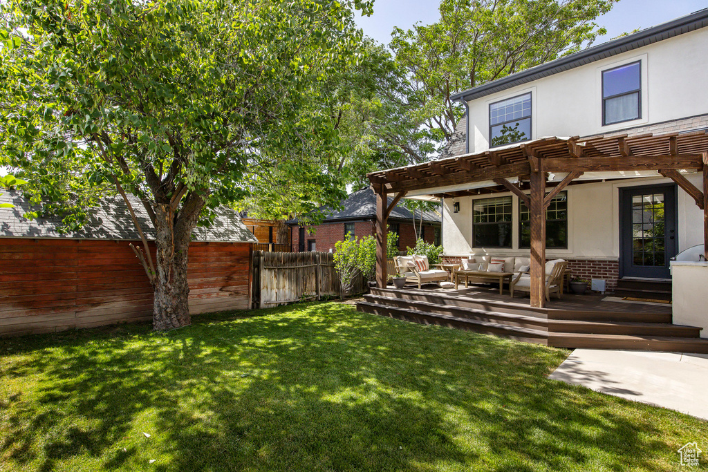 View of yard featuring an outdoor hangout area, a pergola, and a wooden deck