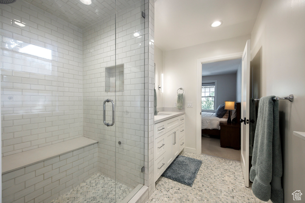 Ensuite bathroom with a stall shower, vanity, and recessed lighting