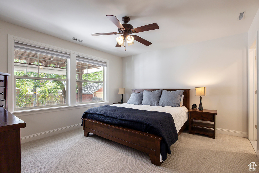 Bedroom featuring light carpet and a ceiling fan