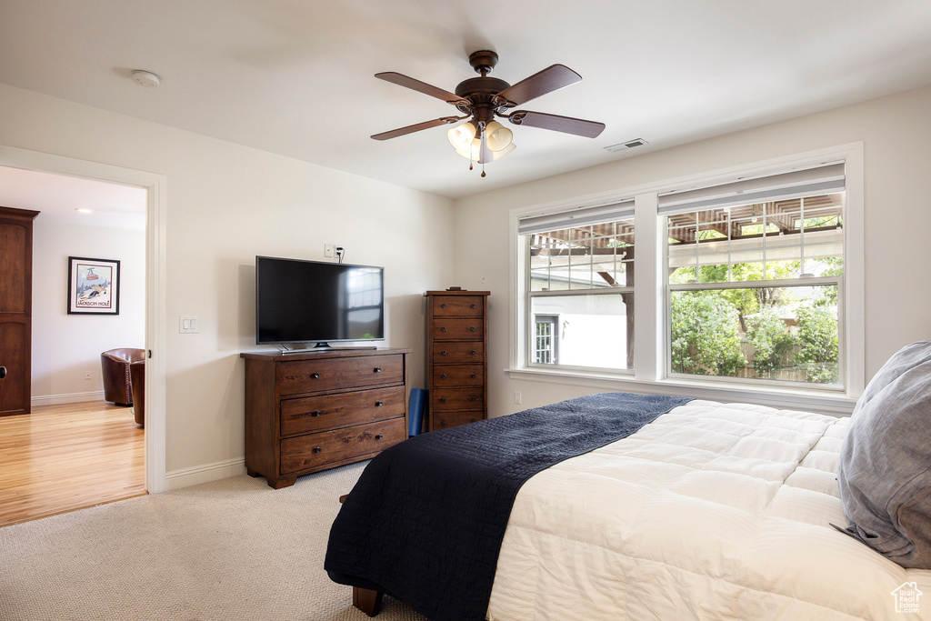 Bedroom featuring light carpet and ceiling fan