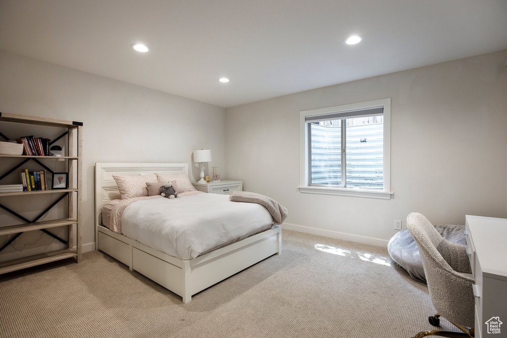 Bedroom with light colored carpet and recessed lighting