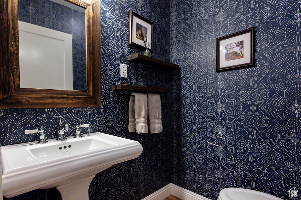 Half bath with a sink and toilet