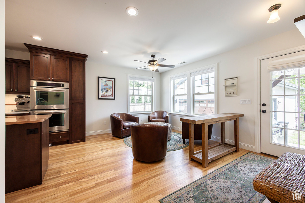 Living room with plenty of natural light, light wood-style flooring, ceiling fan, and recessed lighting