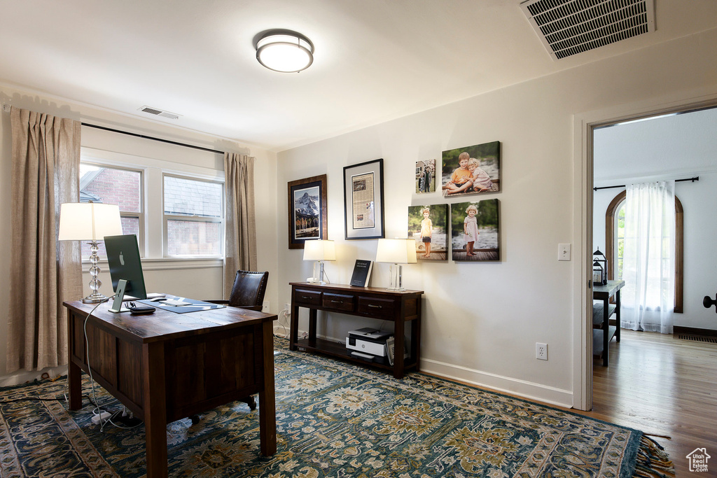 Office space featuring baseboards and wood finished floors