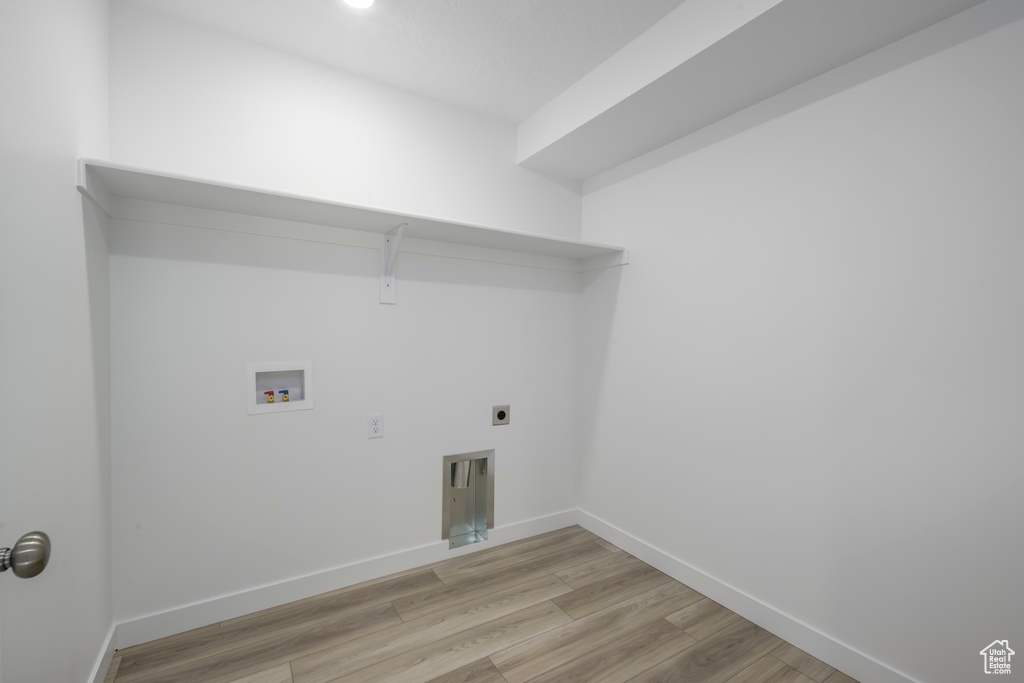 Laundry room featuring hookup for a washing machine, light wood-style floors, and hookup for an electric dryer