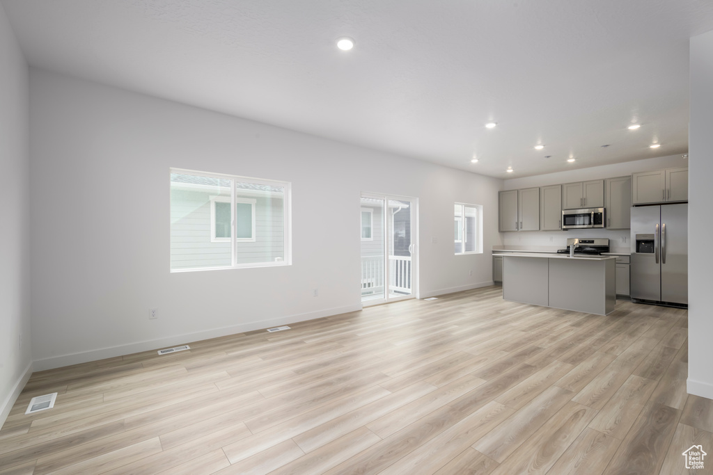 Unfurnished living room featuring light wood-type flooring and recessed lighting