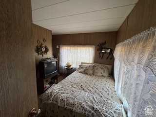 Bedroom featuring wooden walls
