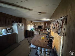 Dining area featuring wooden walls