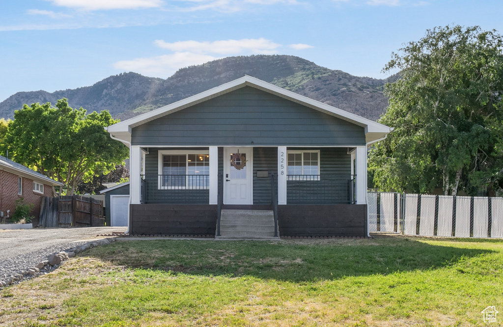 View of front of property with a mountain view and a porch