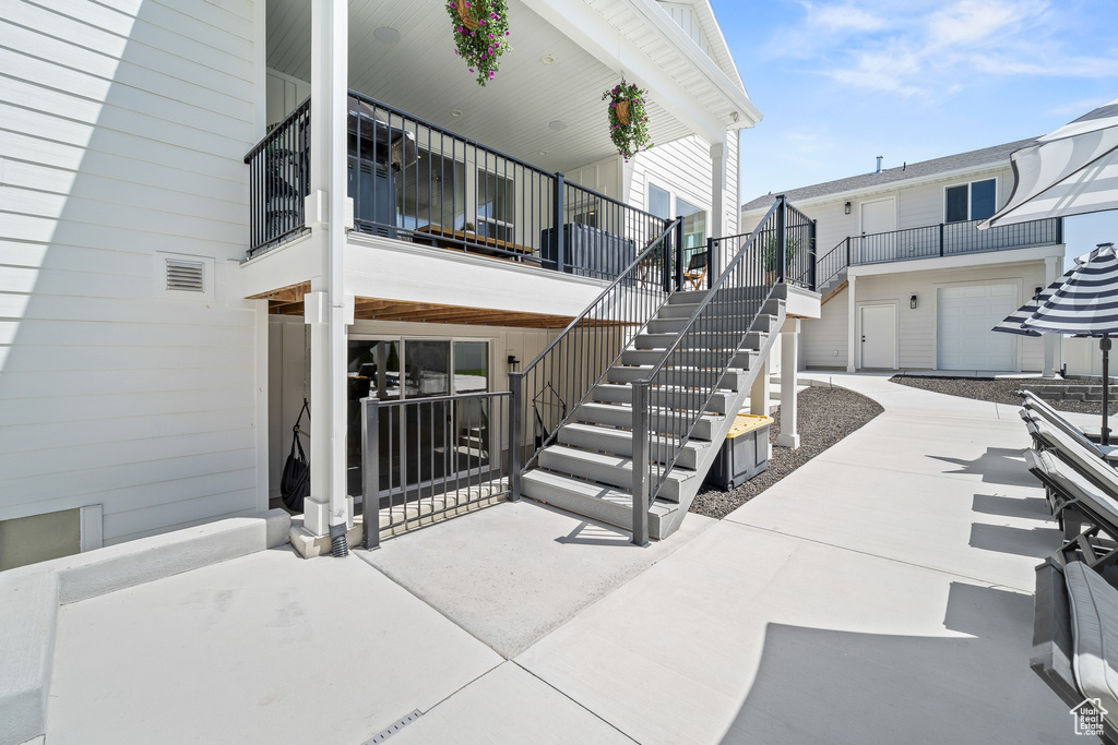 Covered porch featuring stairs