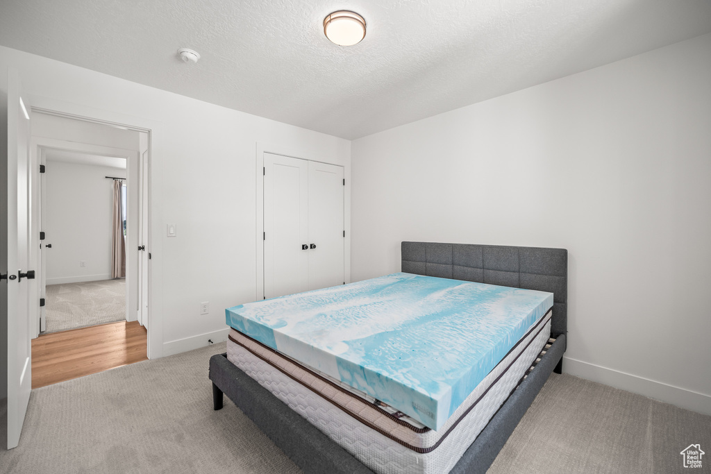 Bedroom with carpet flooring and a closet