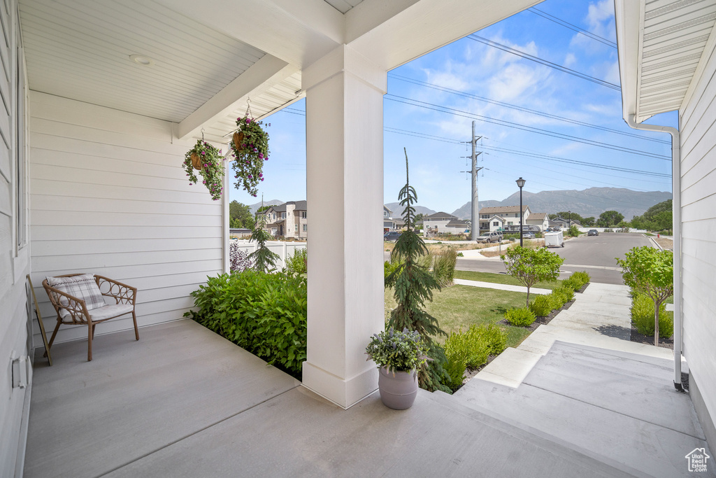 Porch with a mountain view and a residential view