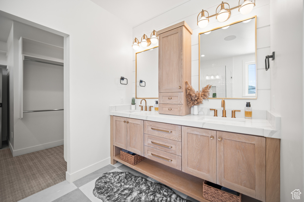Full bath with double vanity and a stall shower