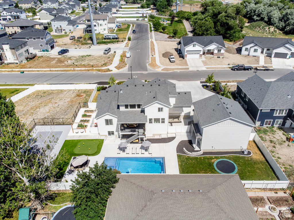 Aerial perspective of suburban area featuring a pool