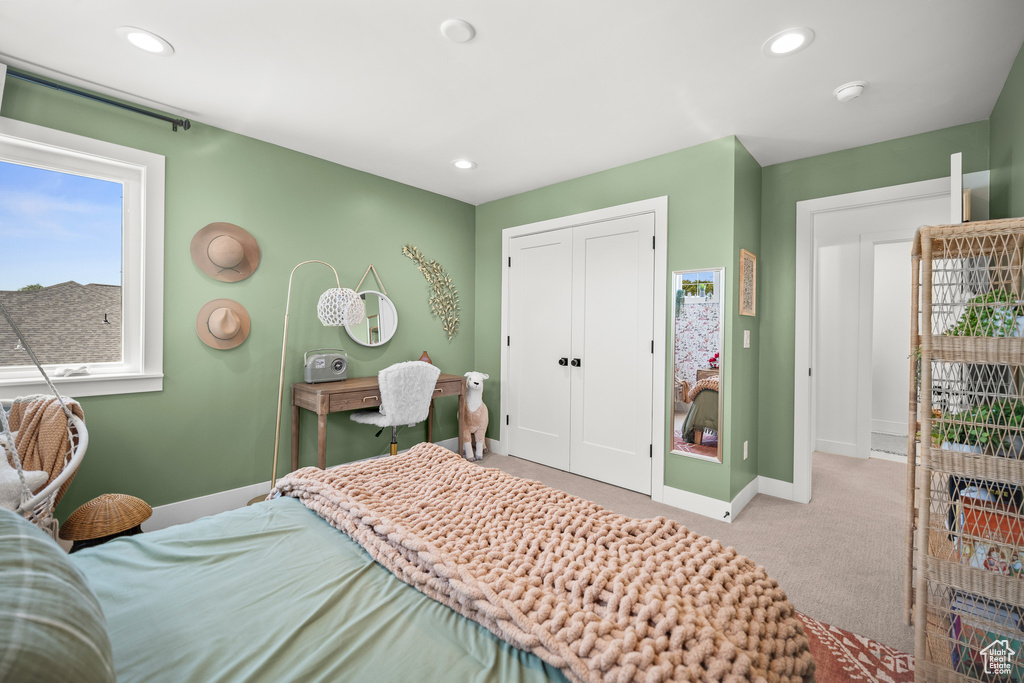 Carpeted bedroom with a closet and recessed lighting