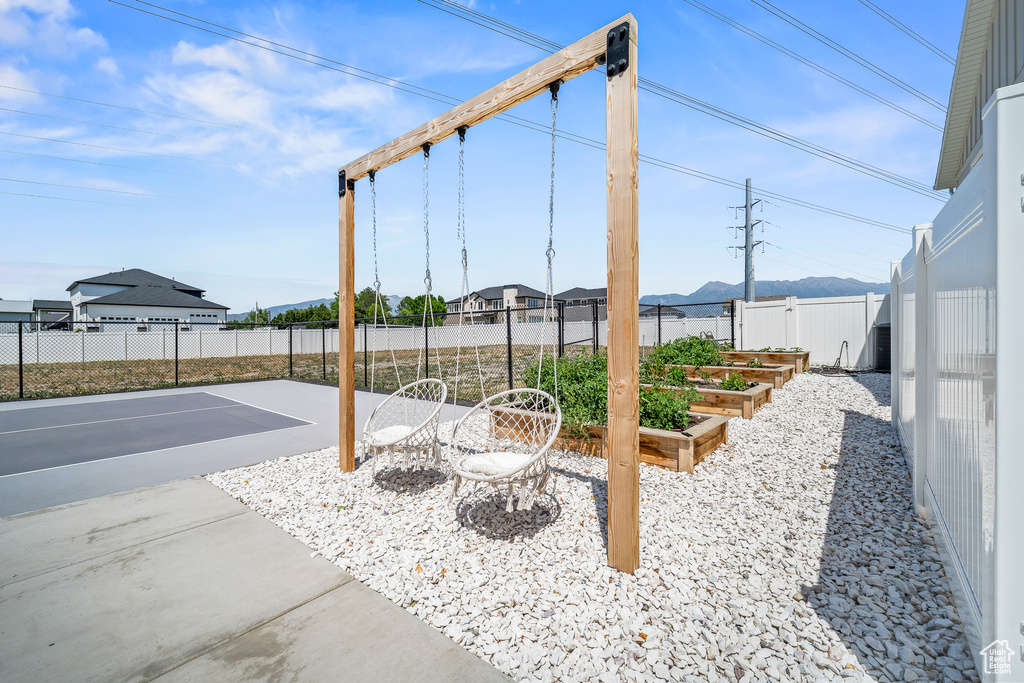 Fenced backyard featuring a garden and a patio area