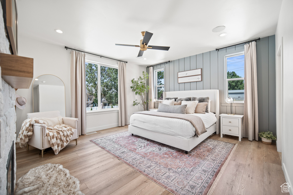 Bedroom featuring light wood-style floors, ceiling fan, and recessed lighting