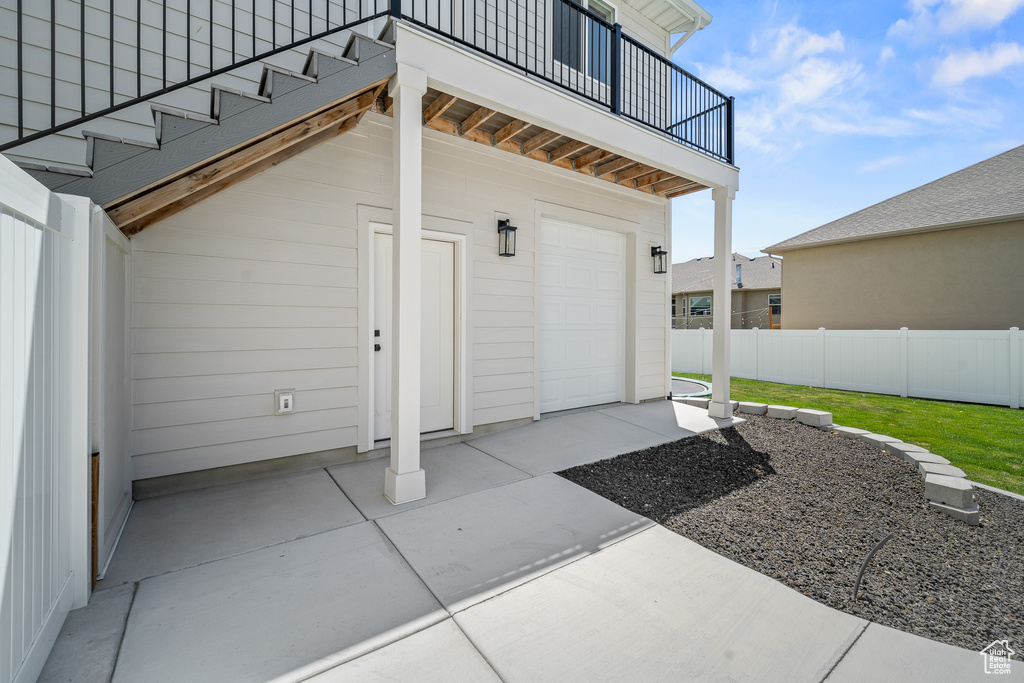 Entrance to property with a balcony and a garage