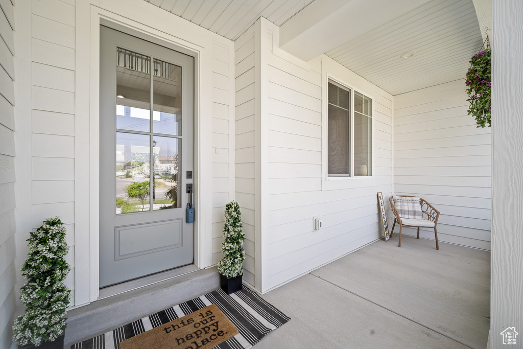 View of exterior entry featuring a porch