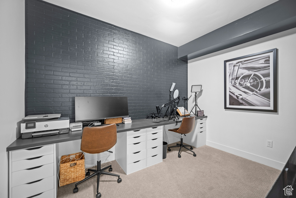 Office area with light colored carpet and baseboards