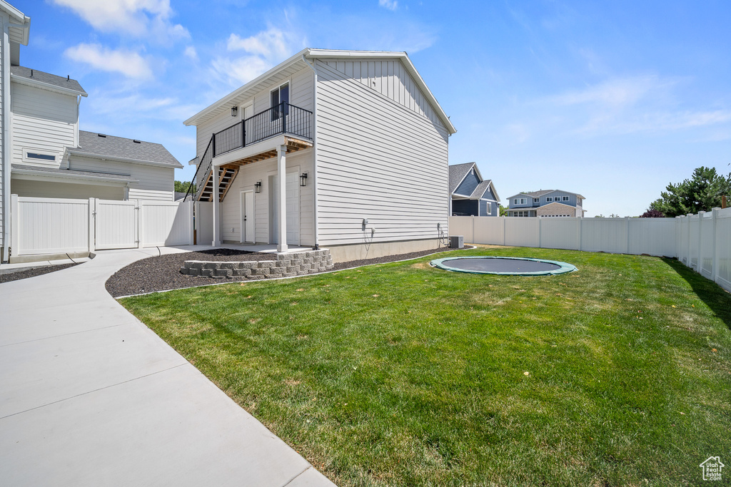 View of home's exterior with a fenced backyard, a gate, and board and batten siding