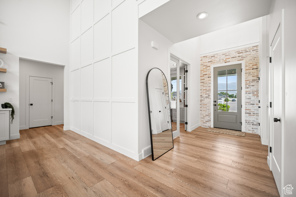 Foyer entrance with light wood-type flooring