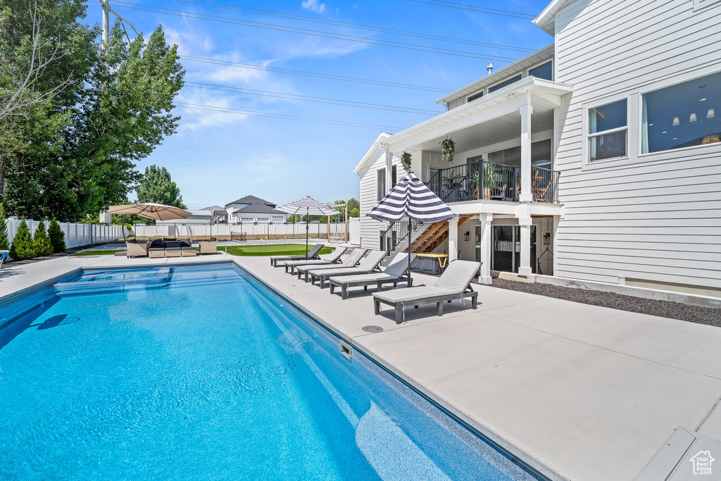View of pool featuring an outdoor hangout area, a patio area, and a fenced backyard