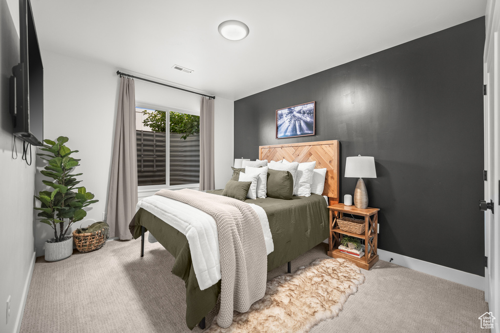 Bedroom featuring carpet and baseboards