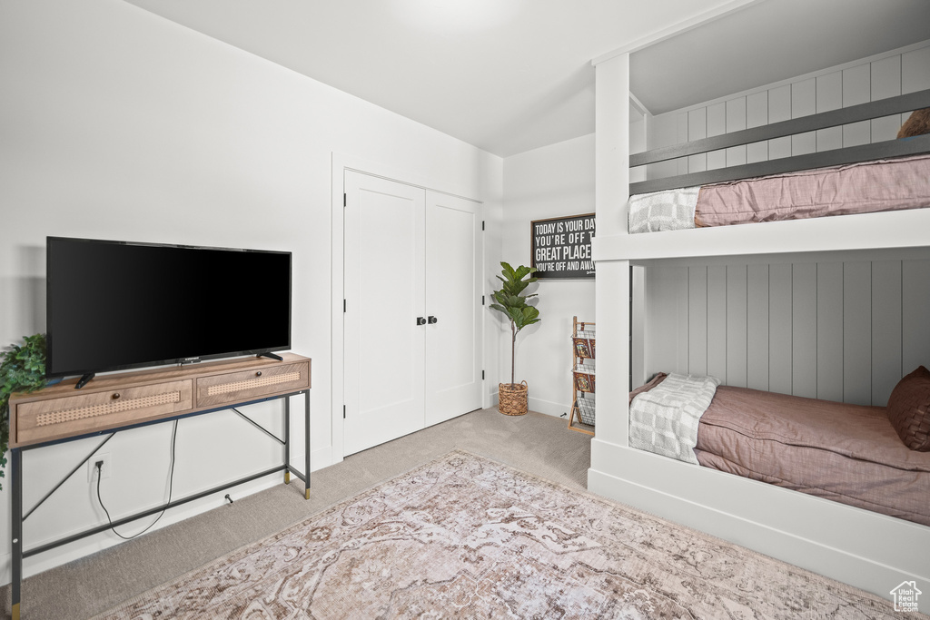 Bedroom with carpet and a closet