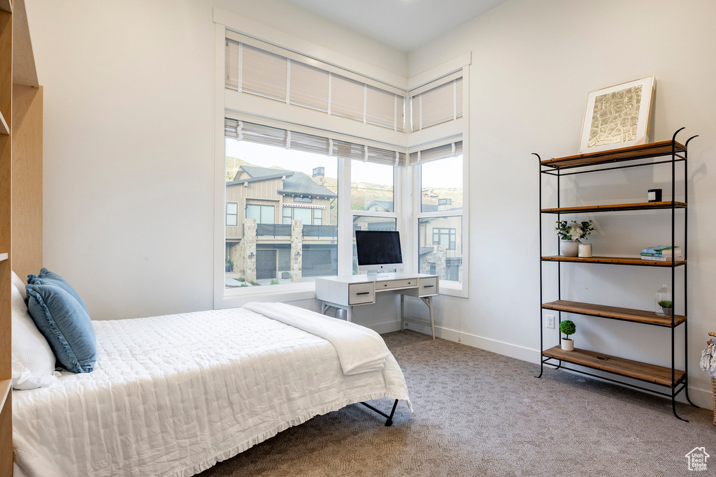 Carpeted bedroom with baseboards
