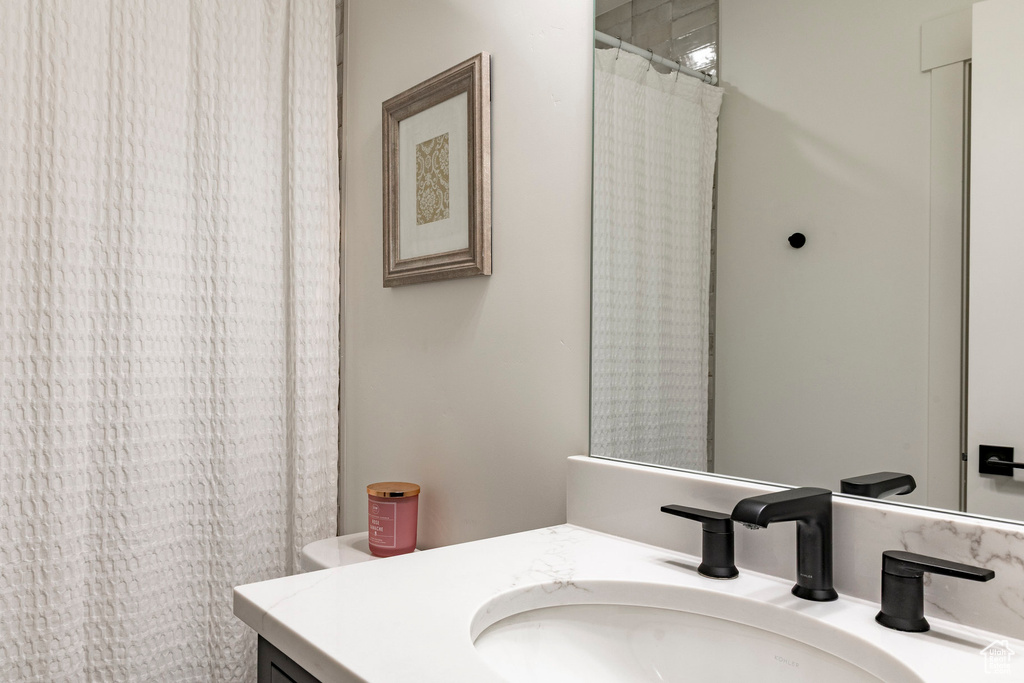Bathroom with vanity and curtained shower
