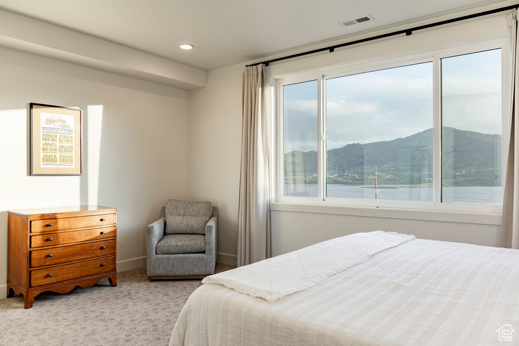 Bedroom featuring light carpet, a mountain view, and recessed lighting