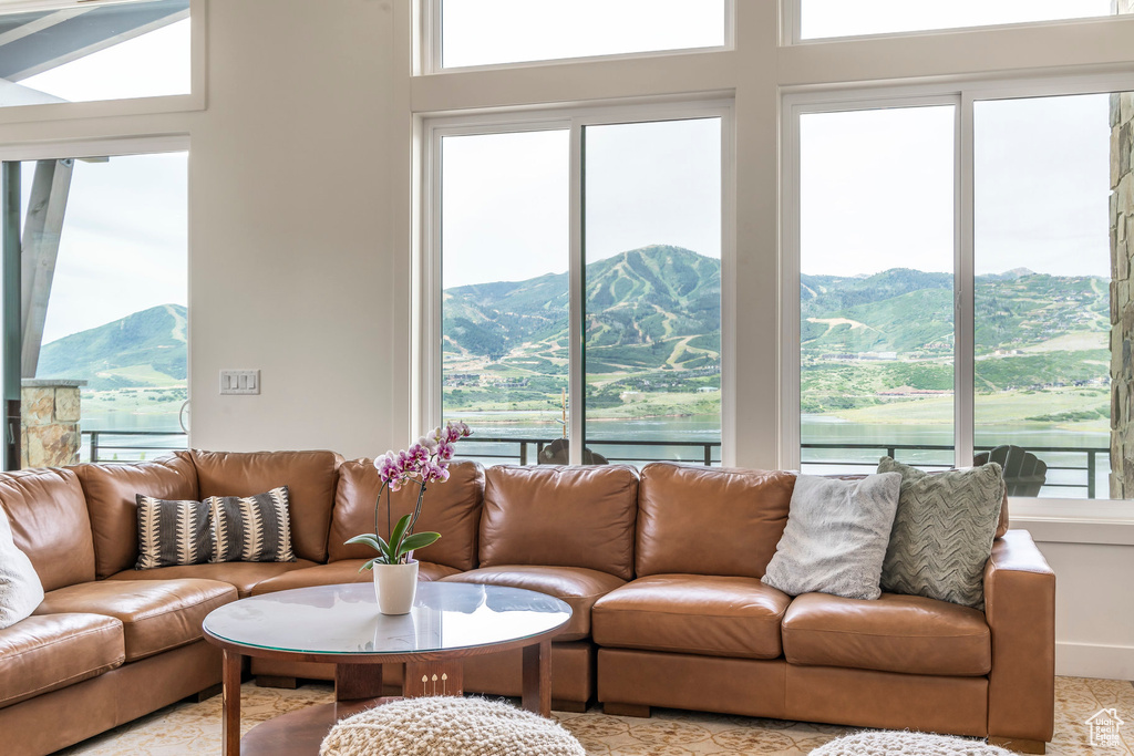 Living area featuring a mountain view and a towering ceiling