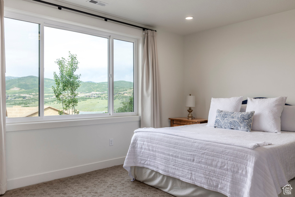 Bedroom featuring carpet flooring, multiple windows, a mountain view, and recessed lighting