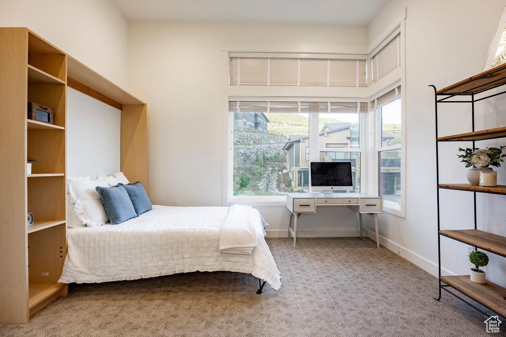 Bedroom featuring carpet flooring and baseboards