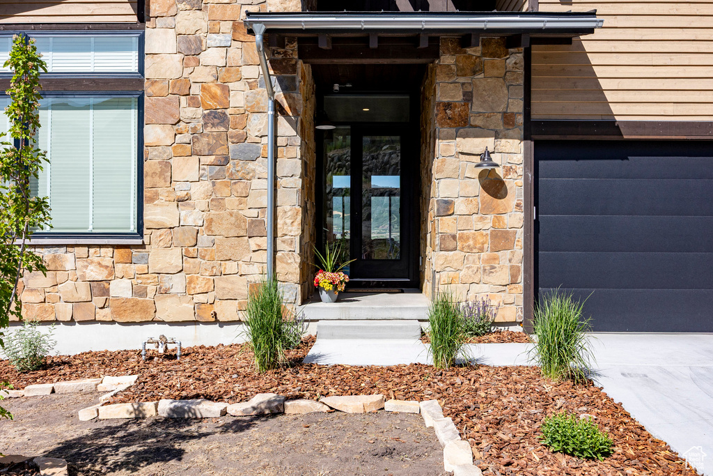 Property entrance featuring stone siding
