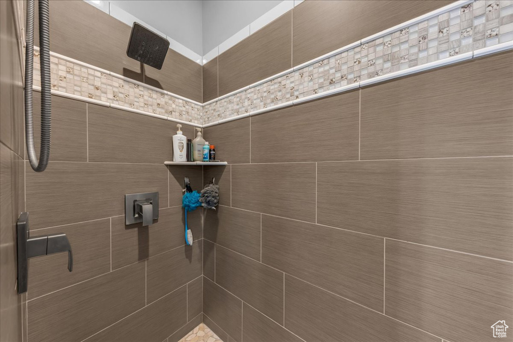 Full bathroom with tiled shower and pet washing station